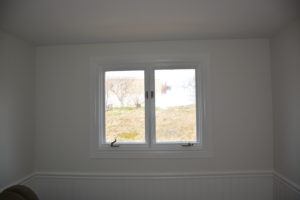 (After) New smooth ceiling, wallpaper removed and old wainscotting painted.